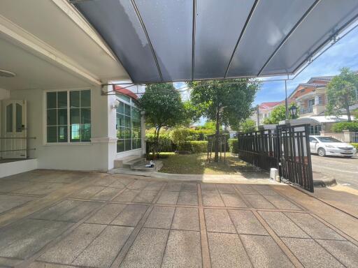 Spacious carport area with a view of the front yard and driveway