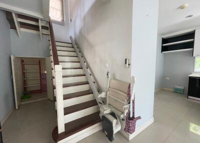 Staircase with a chair lift in a living space