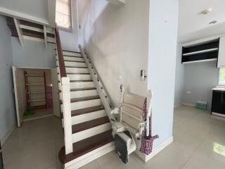 Staircase with a chair lift in a living space