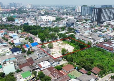 Aerial view of the surrounding neighborhood with a highlighted property