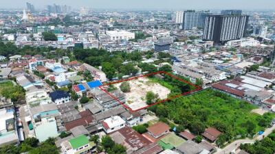 Aerial view of the surrounding neighborhood with a highlighted property