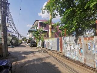 Street view in a residential neighborhood with trees and buildings