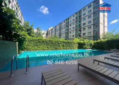 Outdoor swimming pool with lounge chairs in an apartment complex