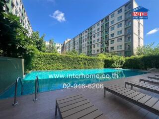 Outdoor swimming pool with lounge chairs in an apartment complex