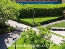 View from building overlooking lush courtyard and pool area