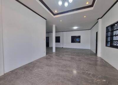 Spacious living room with tiled floor and recessed lighting