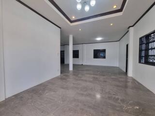 Spacious living room with tiled floor and recessed lighting