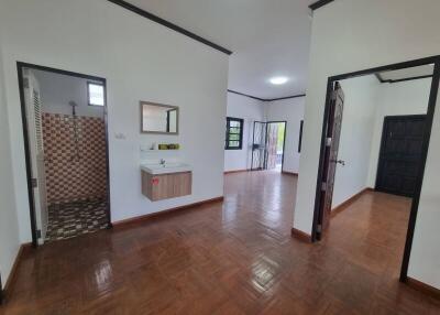 Interior view showing hallway, bathroom, and living area