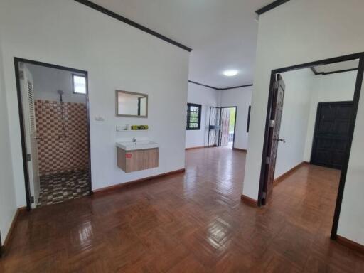 Interior view showing hallway, bathroom, and living area