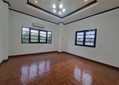 Spacious living room with wooden flooring and ample natural light