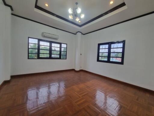 Spacious living room with wooden flooring and ample natural light