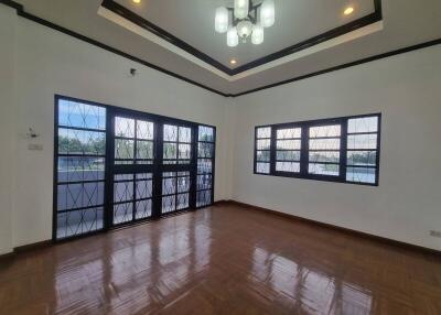 Spacious living room with large windows and elegant lighting