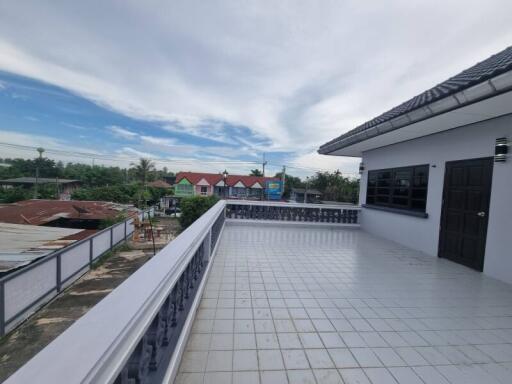 Spacious outdoor balcony with tiled flooring and scenic view