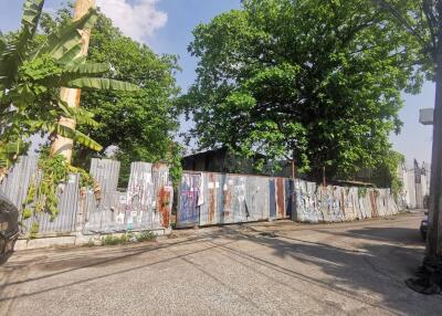 Street view with metal fence and trees