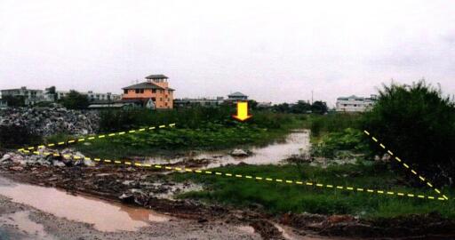 Vacant land plot with nearby buildings