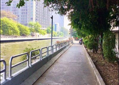 Scenic riverside walkway next to modern residential buildings