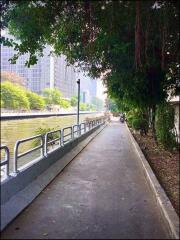 Scenic riverside walkway next to modern residential buildings