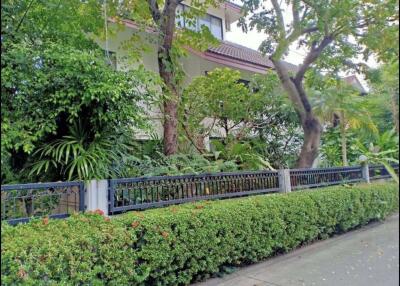 Front view of a residential building with a lush garden