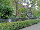 Front view of a residential building with a lush garden