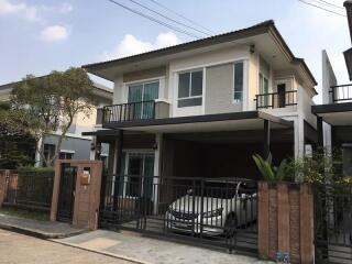 Two-story house with carport and balcony