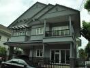 Two-story residential building with a grey exterior