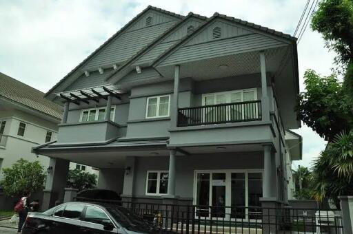 Two-story residential building with a grey exterior