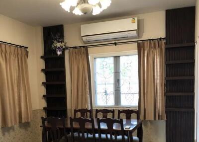 Dining room with wooden table, chairs, air conditioner, and chandelier
