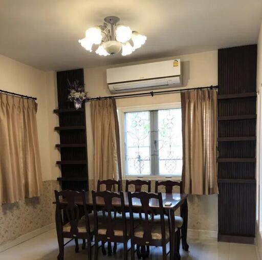 Dining room with wooden table, chairs, air conditioner, and chandelier