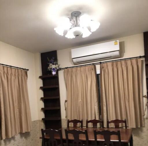 Dining area with table, chairs, and curtains