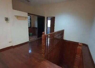 Spacious staircase landing with wooden flooring