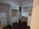 Walk-in closet with shelves and hanging space