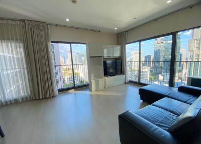 Modern living room with large windows and city view