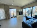 Modern living room with large windows and city view