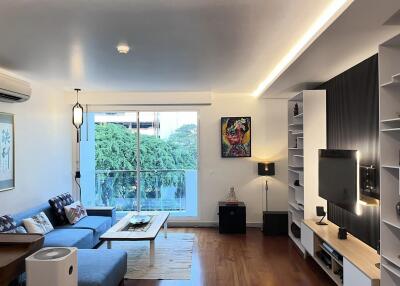 Contemporary living room with a large window and modern furnishings