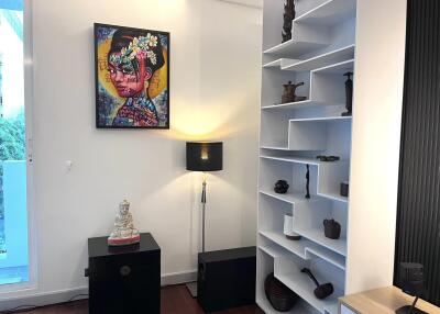 Living room with decorative shelf and artwork