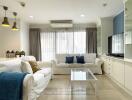 Bright and spacious living room with white sofas and natural lighting