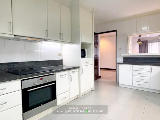 Modern kitchen with white cabinets and black countertops