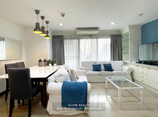 Modern living room with dining area and natural lighting