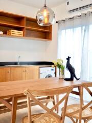 Modern kitchen with wooden cabinets and dining area