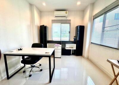 Modern home office with desk, chair, and shelving units