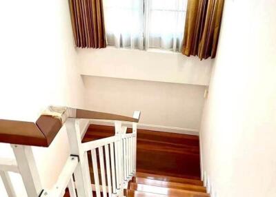 staircase with sunlight coming through window