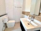 Contemporary bathroom with white fixtures and large mirror