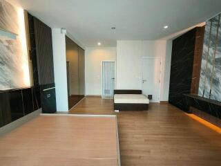 Modern bedroom with hardwood floors and accent wall