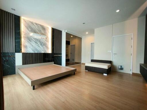 Spacious modern bedroom with bed and minimalist decor