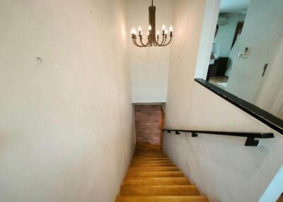 Interior staircase with chandelier