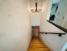 Interior staircase with chandelier