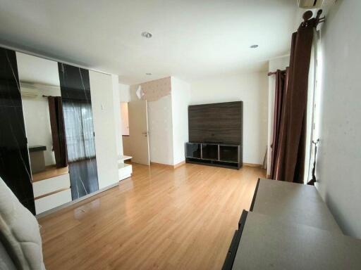 spacious living room with wooden flooring