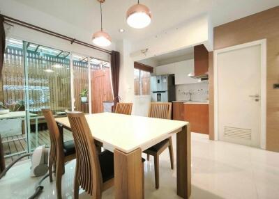 Modern kitchen and dining area with wooden furniture