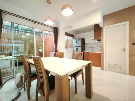 Modern kitchen and dining area with wooden furniture