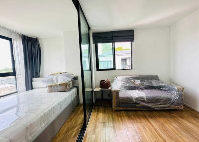 spacious bedroom with large window and mirrored closet